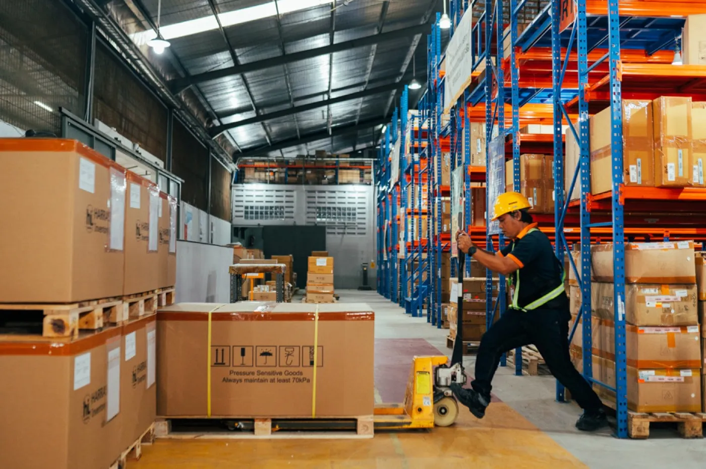 Pallet jack moving boxes in warehouse